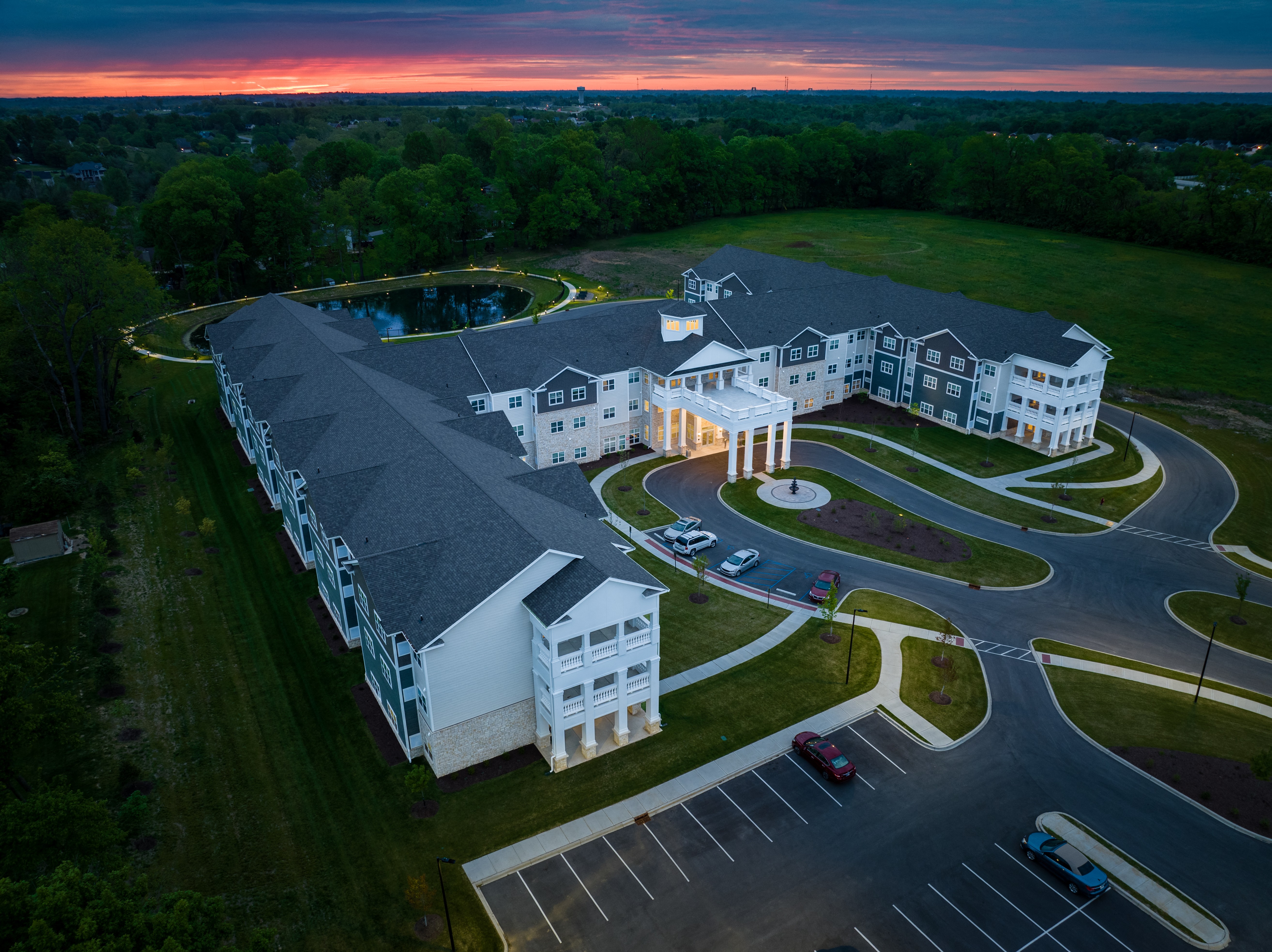 a large building with a sunset in the background